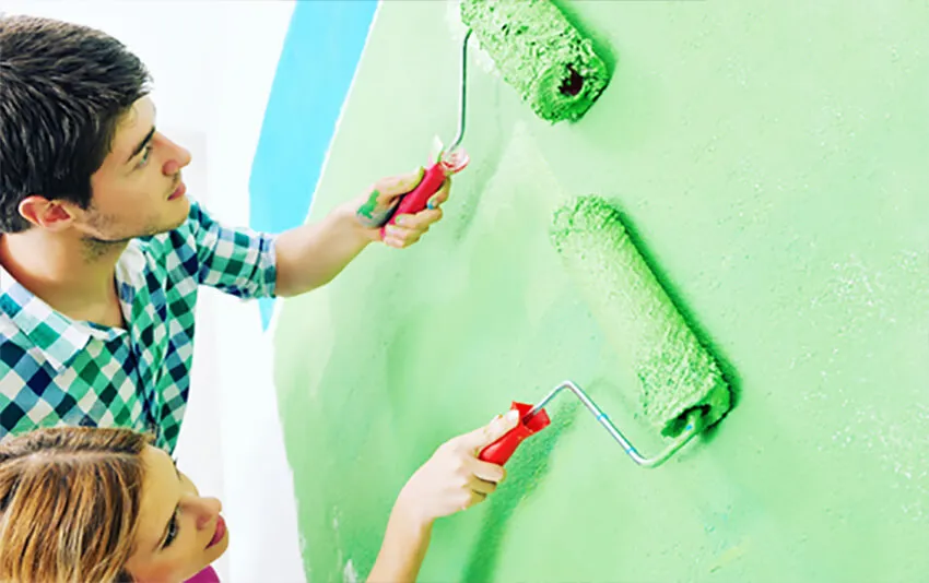 happy-couple-paint-wall-at-new-h